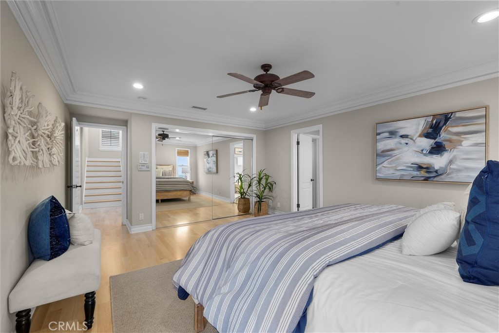 1042 Bayview Drive Hermosa Beach, CA 90254 - Photo 22 of 44 a bedroom with a large bed and a chandelier