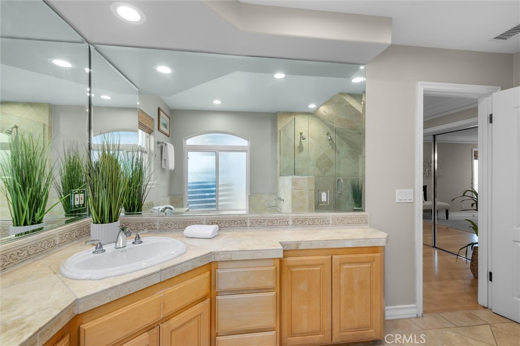 1042 Bayview Drive Hermosa Beach, CA 90254 - Photo 26 of 44 a bathroom with a granite countertop sink a mirror and a shower