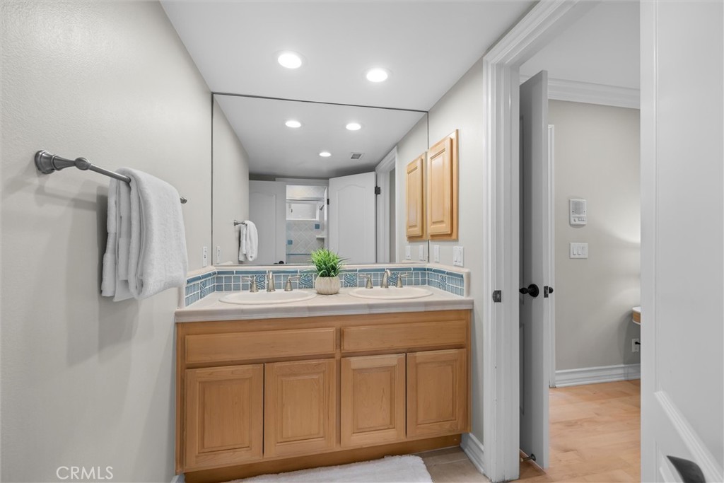 1042 Bayview Drive Hermosa Beach, CA 90254 - Photo 31 of 44 a bathroom with a granite countertop sink a shower and a mirror