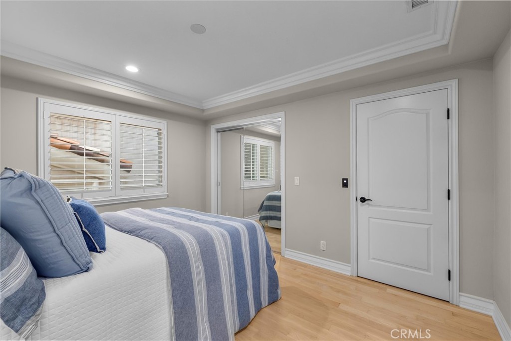 1042 Bayview Drive Hermosa Beach, CA 90254 - Photo 34 of 44 a bedroom with a large bed and wooden floor