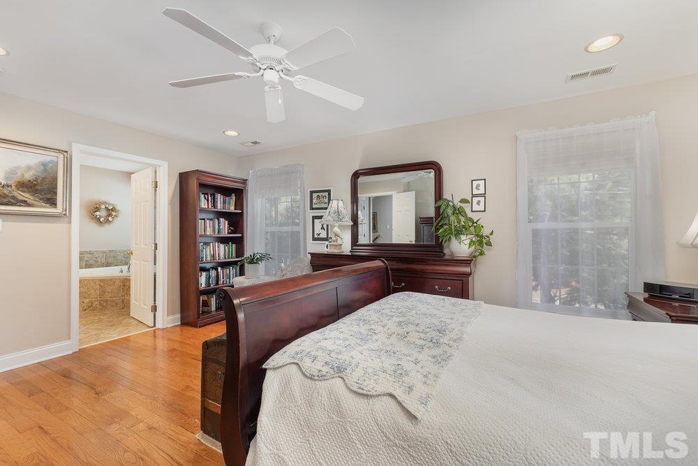 10122 Mizner Lane Raleigh, NC 27617 - Photo 17 of 31 a bedroom with a large bed and a dresser