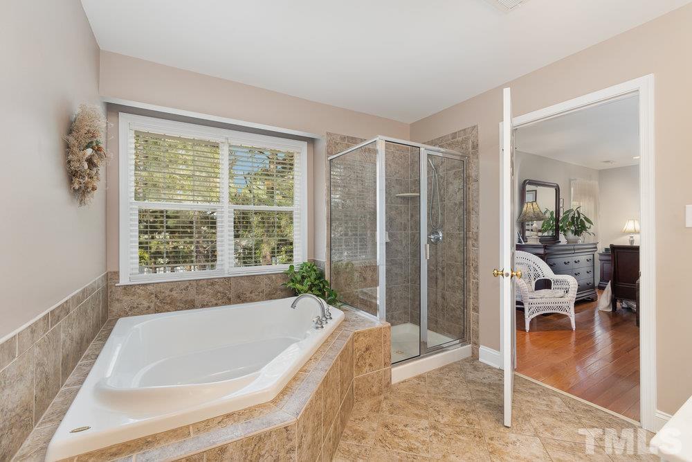 10122 Mizner Lane Raleigh, NC 27617 - Photo 19 of 31 a spacious bathroom with a tub and shower