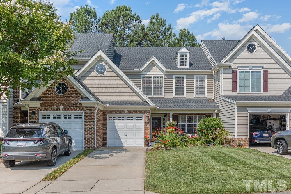 10122 Mizner Lane Raleigh, NC 27617 - Photo 2 of 31 a front view of a house with a garden and parking