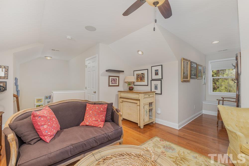 10122 Mizner Lane Raleigh, NC 27617 - Photo 23 of 31 a living room with furniture and wooden floor