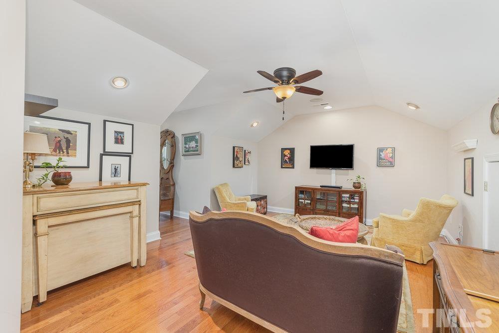 10122 Mizner Lane Raleigh, NC 27617 - Photo 24 of 31 a living room with furniture and a flat screen tv