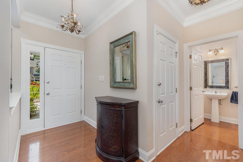 10122 Mizner Lane Raleigh, NC 27617 - Photo 6 of 31 a view of a hallway with a dining table and chairs