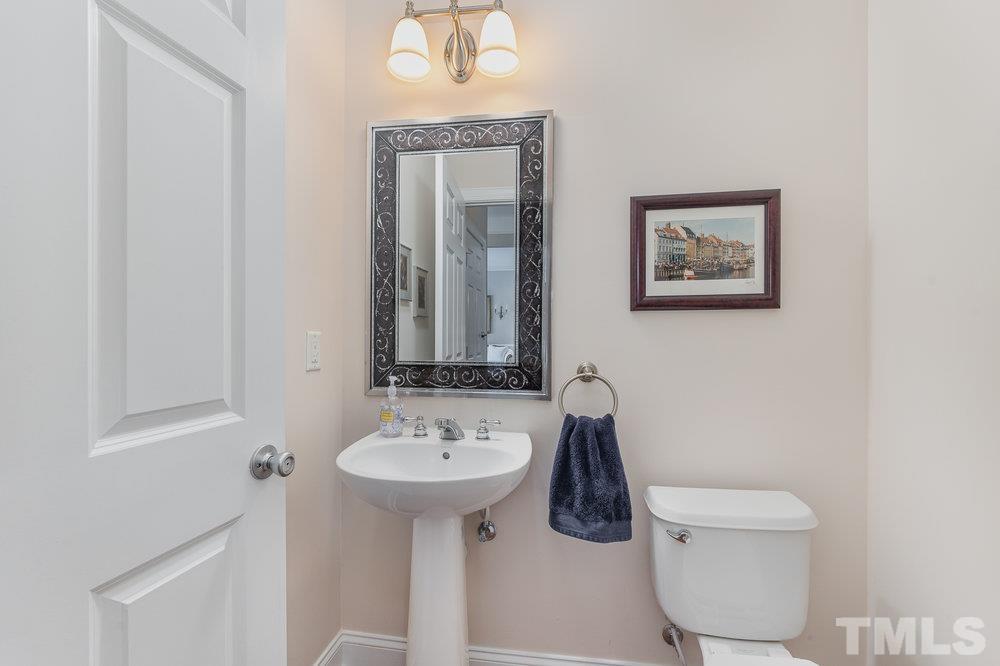 10122 Mizner Lane Raleigh, NC 27617 - Photo 10 of 31 a bathroom with a toilet sink and mirror