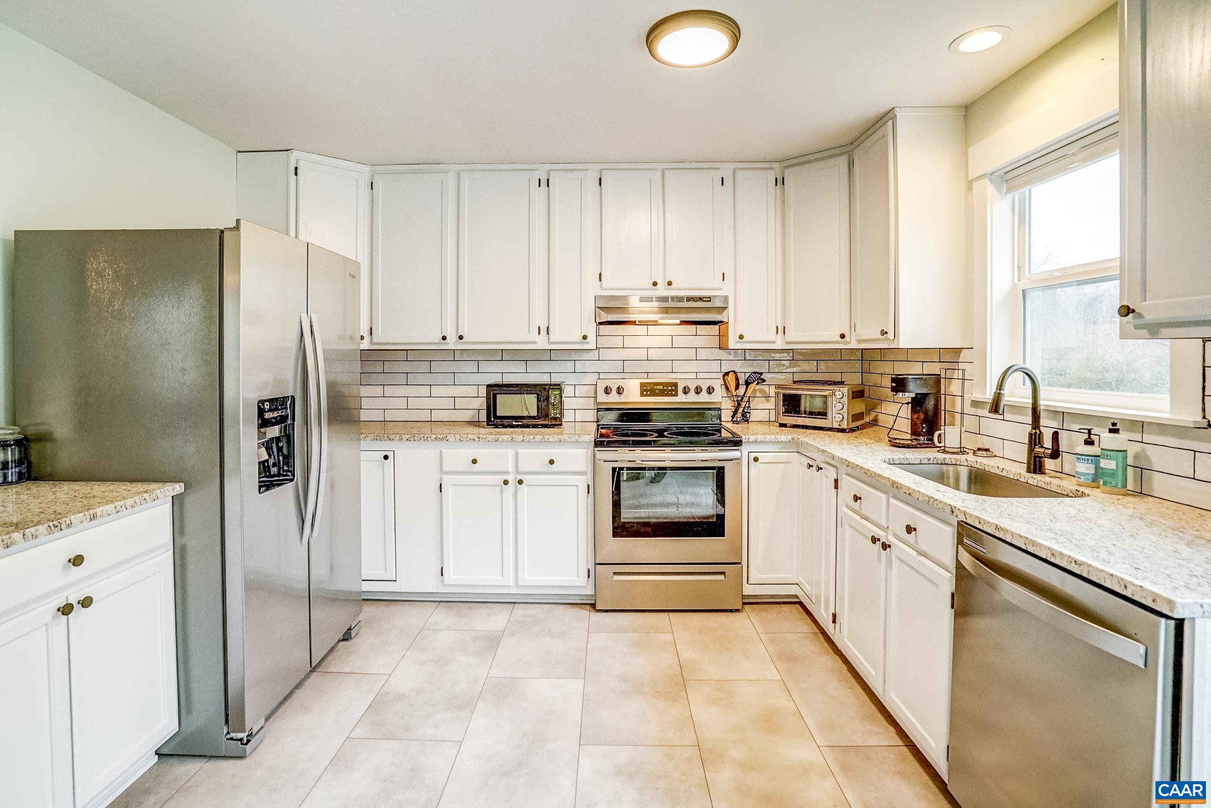 1265 Pounding Creek Road Charlottesville, VA 22903 - Photo 22 of 71 a kitchen with stainless steel appliances granite countertop a stove a sink and a refrigerator