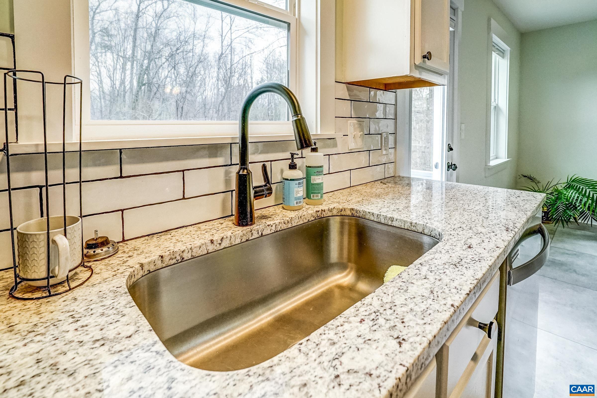 1265 Pounding Creek Road Charlottesville, VA 22903 - Photo 25 of 71 a view of a kitchen island with a sink and a dining table