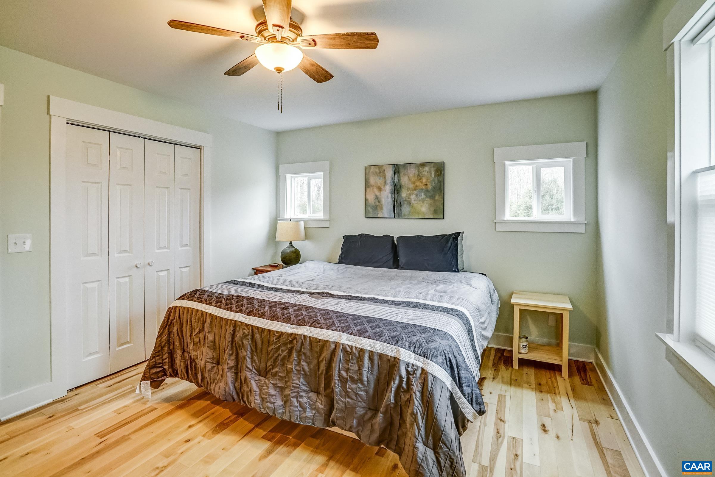 1265 Pounding Creek Road Charlottesville, VA 22903 - Photo 29 of 71 a bedroom with a bed and a chandelier
