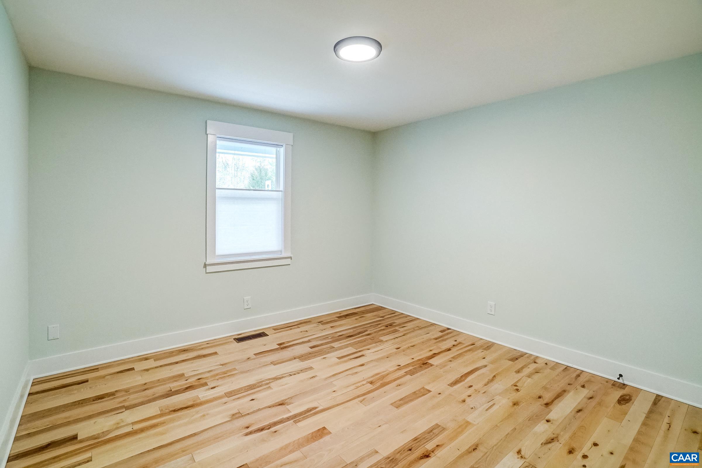 1265 Pounding Creek Road Charlottesville, VA 22903 - Photo 32 of 71 a view of empty room with wooden floor and fan