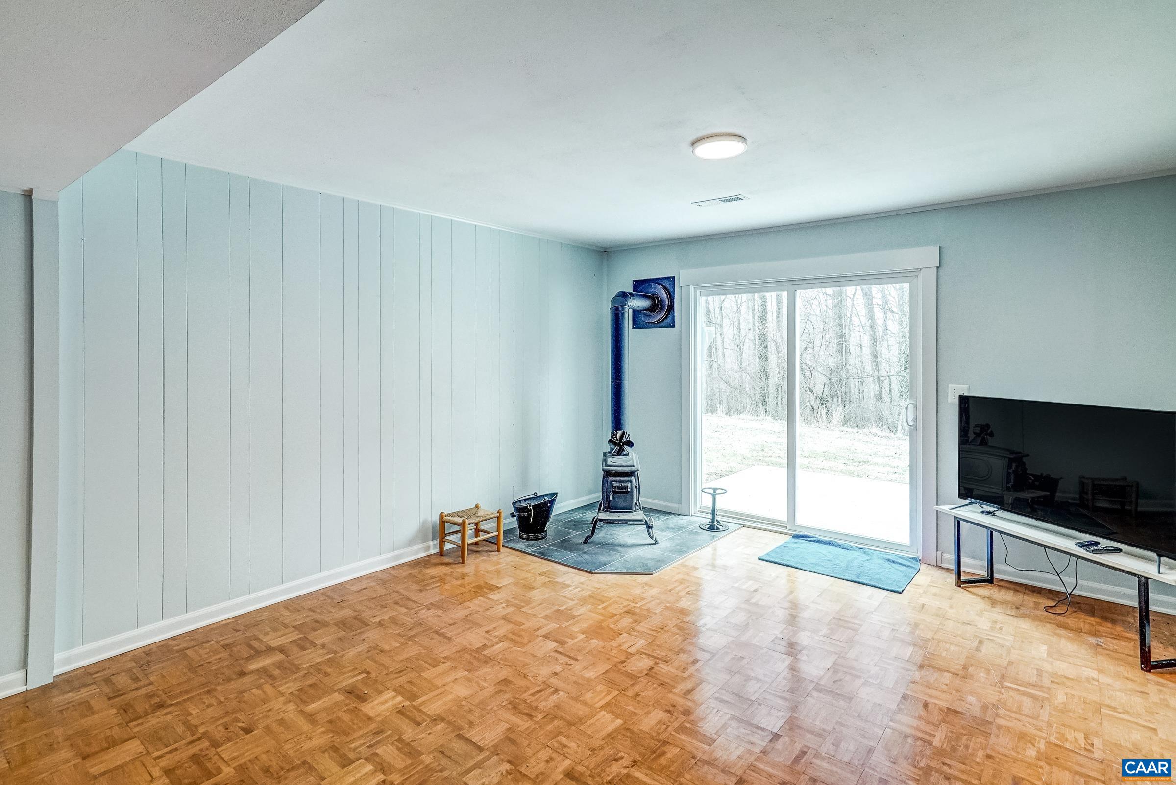 1265 Pounding Creek Road Charlottesville, VA 22903 - Photo 38 of 71 a view of a livingroom with wooden floor and a flat screen tv