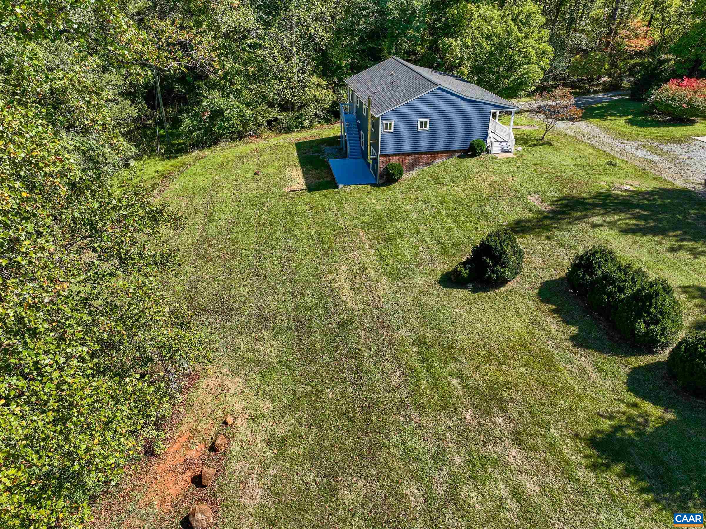 1265 Pounding Creek Road Charlottesville, VA 22903 - Photo 4 of 71 a yellow house with trees in front of it