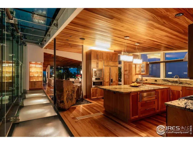 a view of a living room with stainless steel appliances granite countertop furniture and a kitchen view