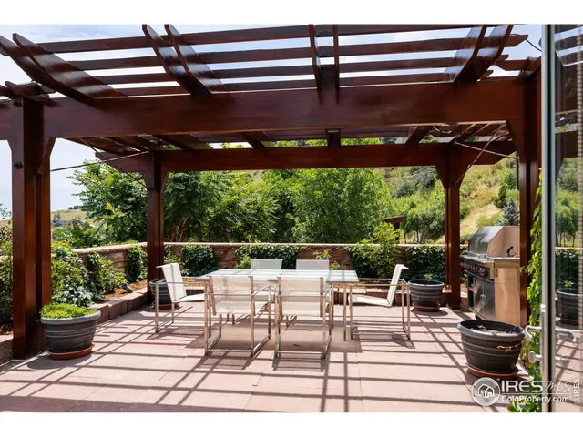 a building outdoor space with patio furniture and potted plants