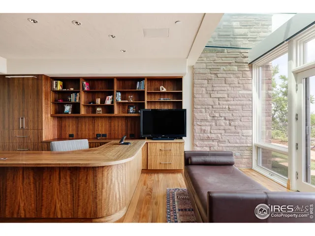 a kitchen view with a table chairs and wooden floor