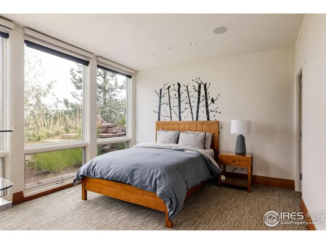 a bedroom with a bed and a large window