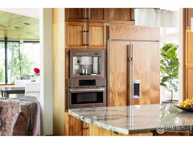 a kitchen with stainless steel appliances granite countertop a refrigerator and a stove