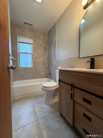 a bathroom with a sink a toilet and a bathtub