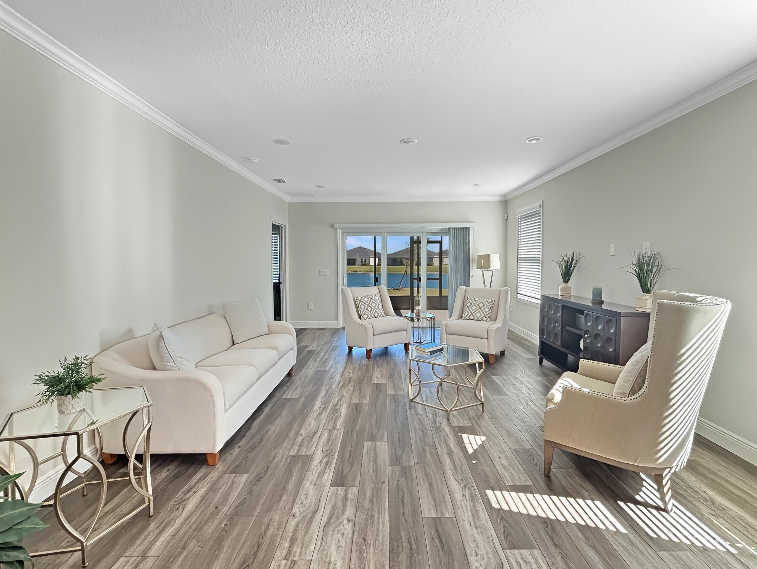 9399 Southwest Serapis Way Port Port St. Lucie, FL 34987 - Photo 11 of 43 a living room with furniture and a table