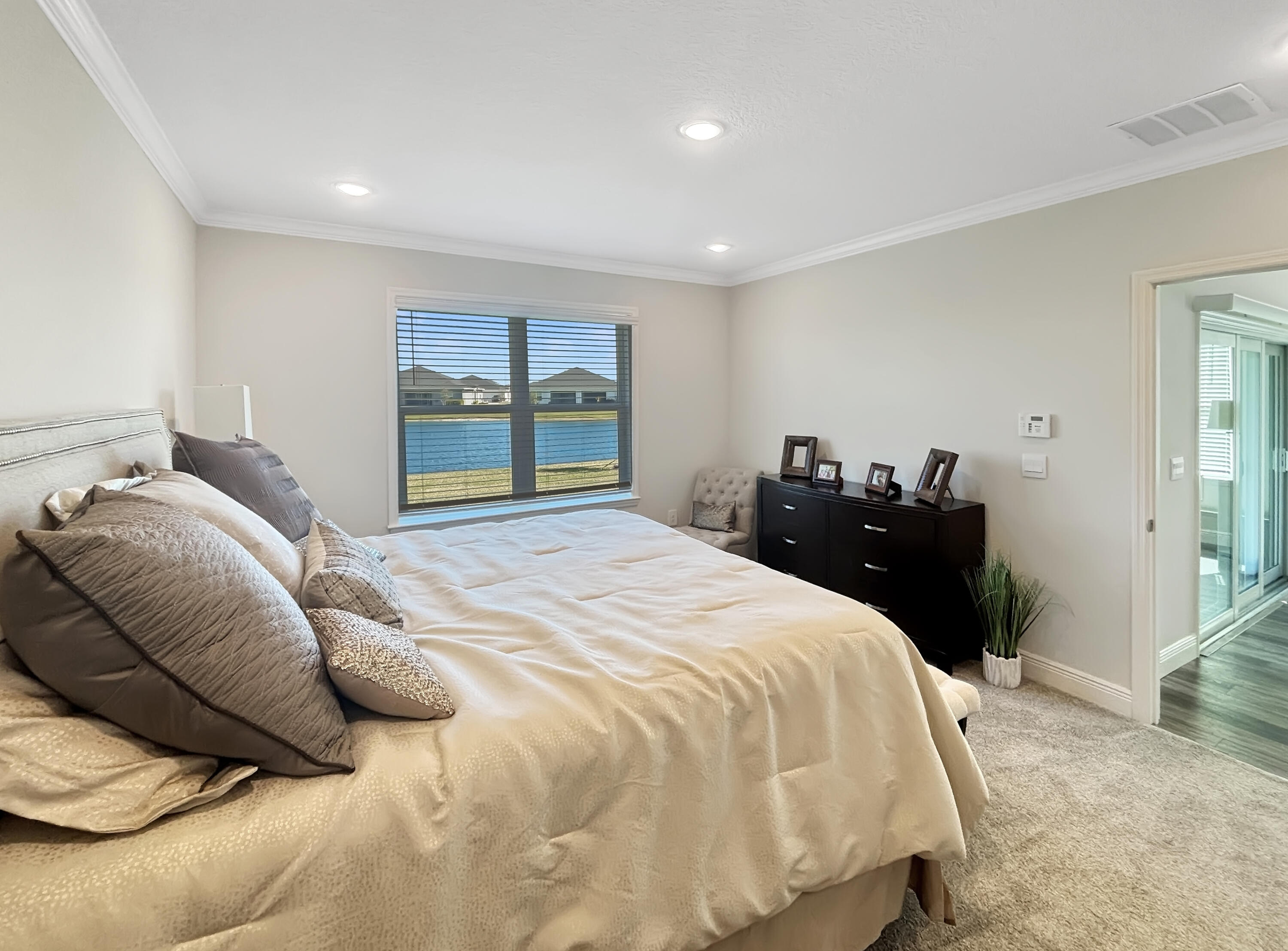 9399 Southwest Serapis Way Port Port St. Lucie, FL 34987 - Photo 13 of 43 a bedroom with a bed and window
