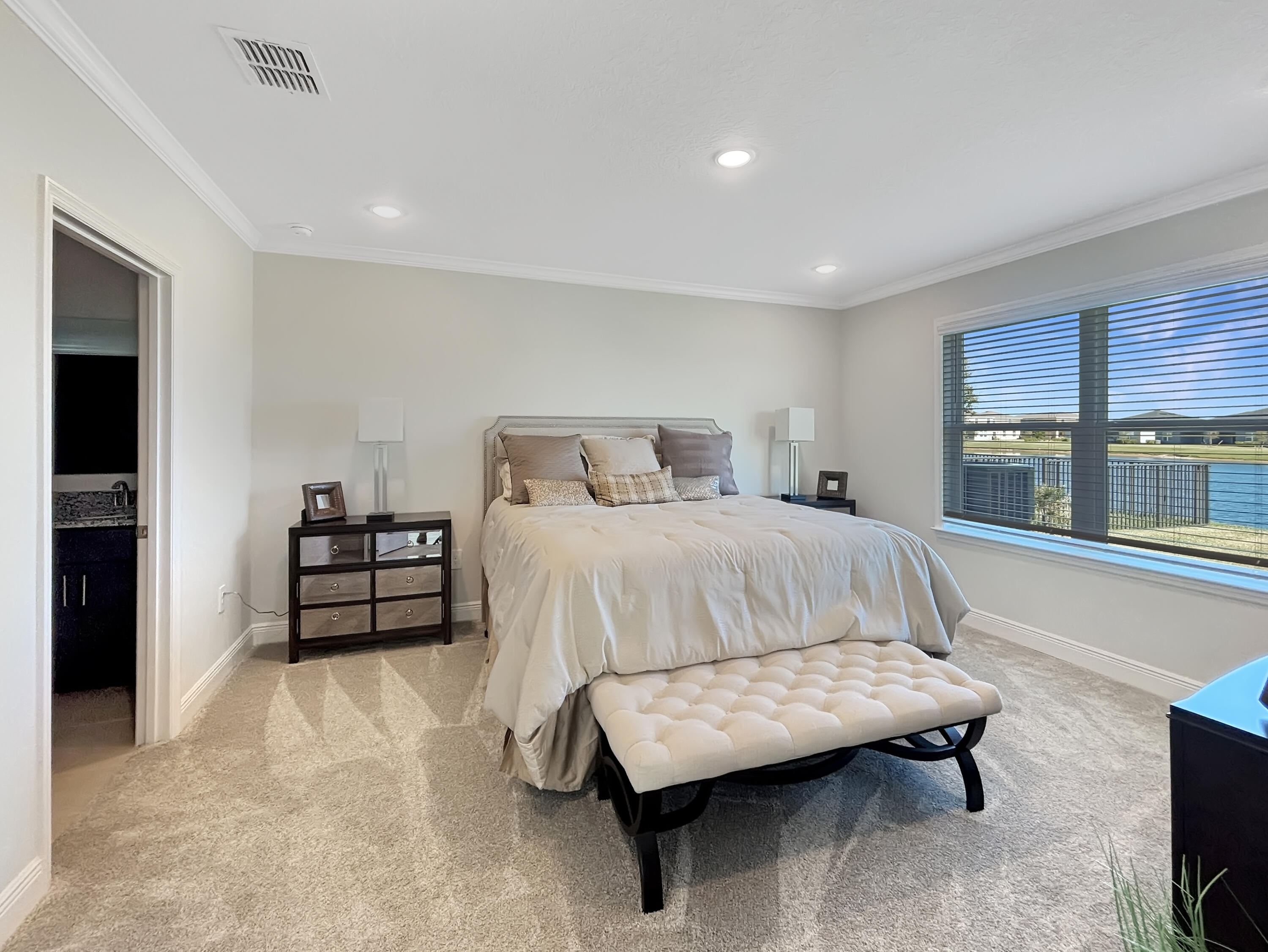 9399 Southwest Serapis Way Port Port St. Lucie, FL 34987 - Photo 18 of 43 a bedroom with furniture and a flat screen tv