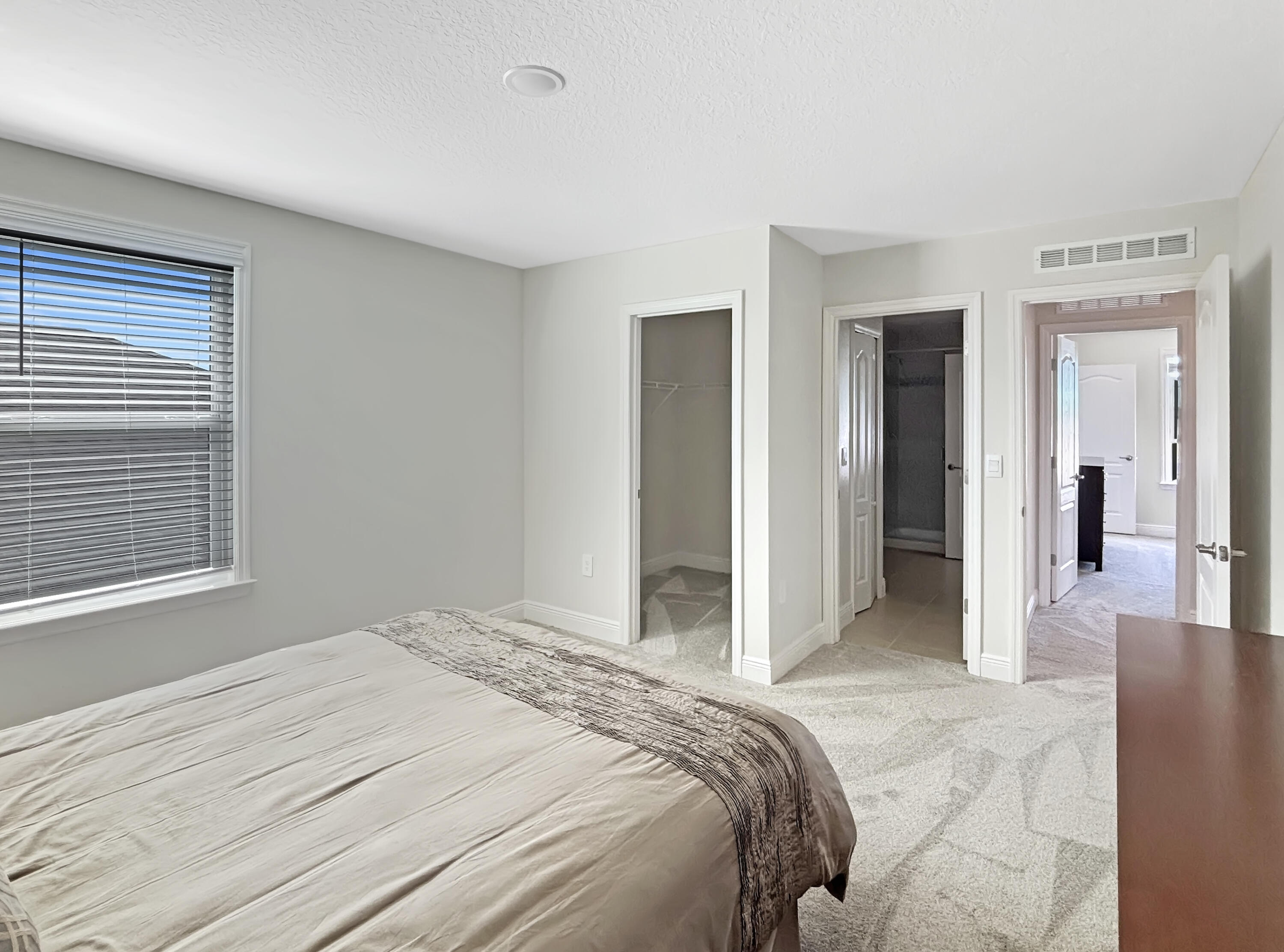 9399 Southwest Serapis Way Port Port St. Lucie, FL 34987 - Photo 26 of 43 a bedroom with a bed and a window