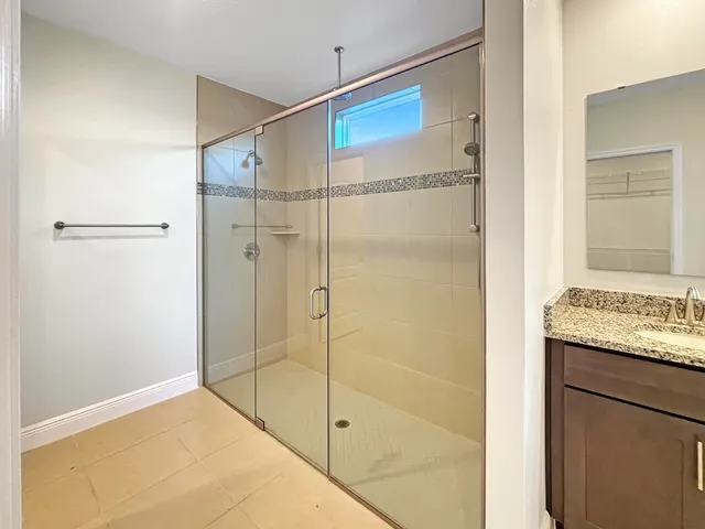 a bathroom with a shower and a sink