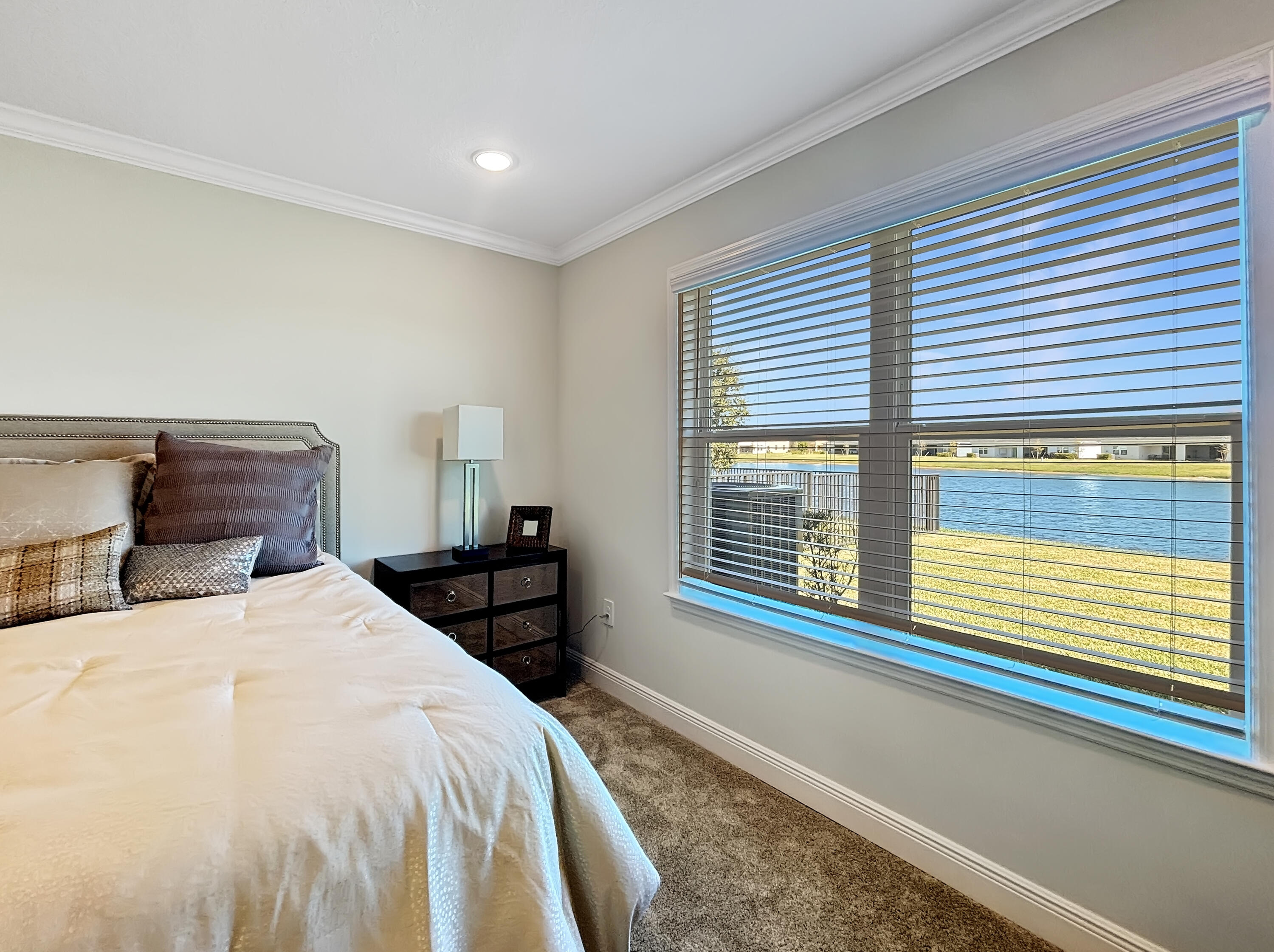 9399 Southwest Serapis Way Port Port St. Lucie, FL 34987 - Photo 32 of 43 a bedroom with a bed and a large window