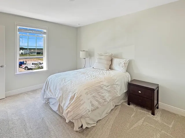 a bedroom with a bed and window