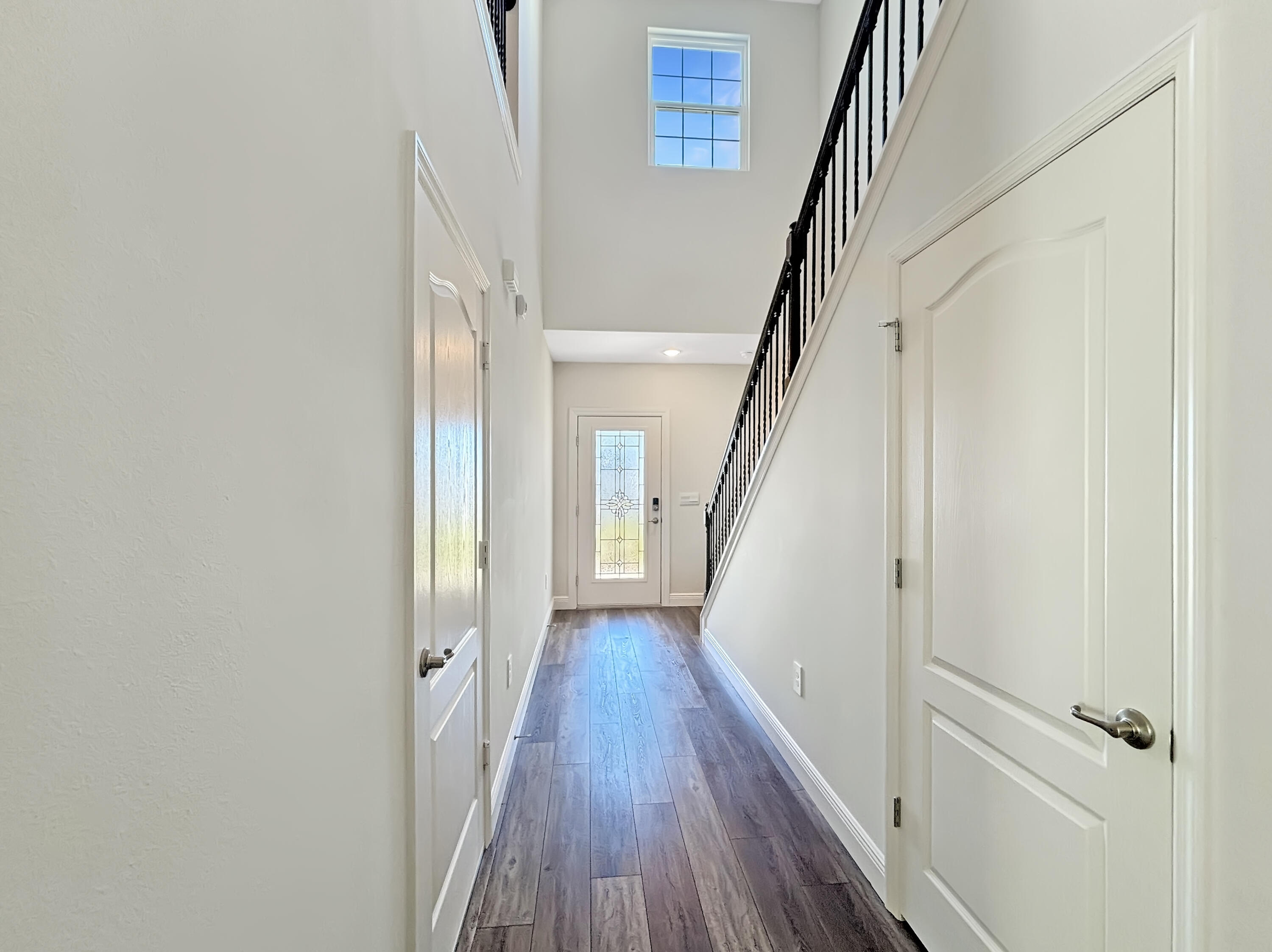 9399 Southwest Serapis Way Port Port St. Lucie, FL 34987 - Photo 5 of 43 a view of a hallway with wooden floor and staircase