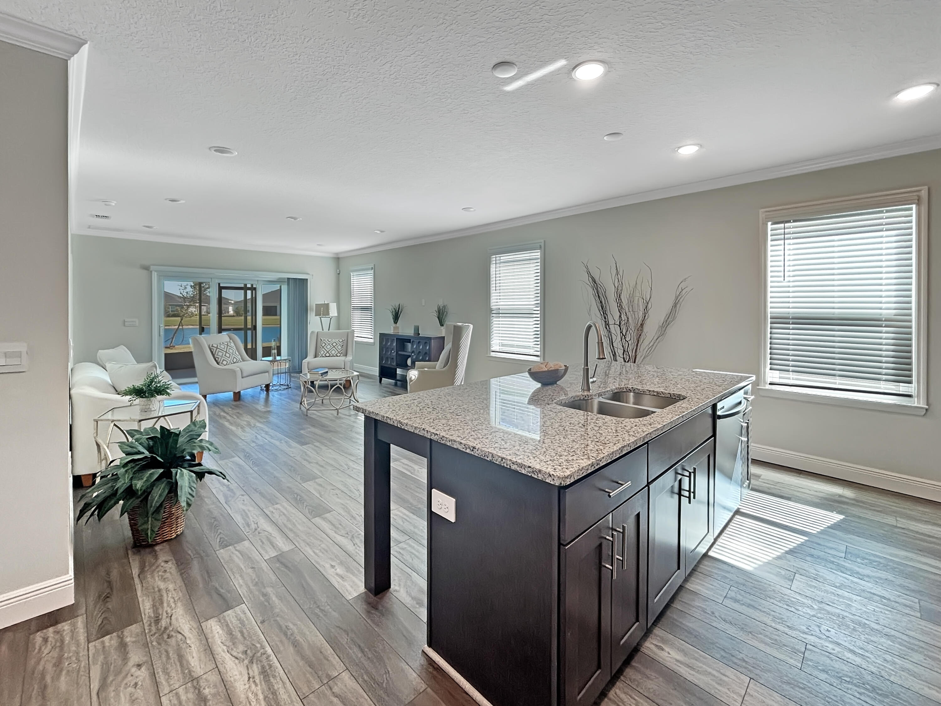 9399 Southwest Serapis Way Port Port St. Lucie, FL 34987 - Photo 9 of 43 a kitchen with counter space and wooden floor