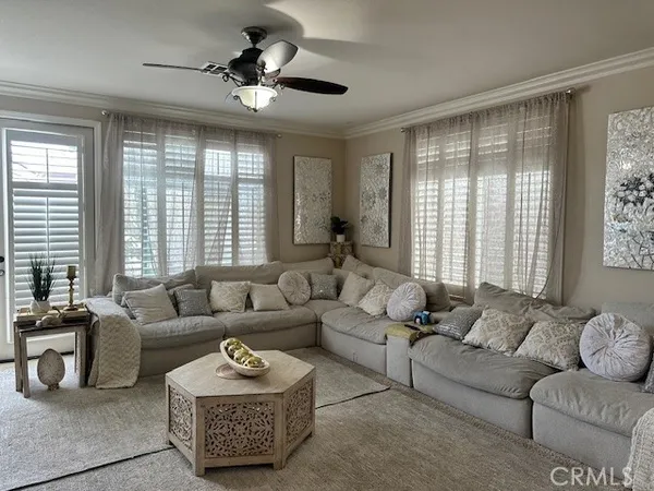 a living room with furniture ceiling and a large window