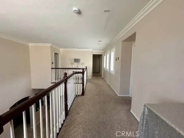a view of a hallway with stairs