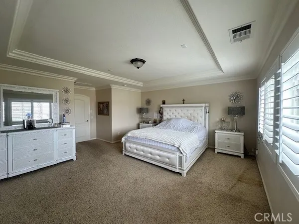 a spacious bedroom with a bed and a window