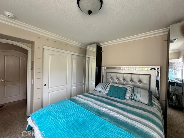 23422 Camino Terraza Road Corona, CA 92883 - Photo 36 of 47 a bedroom with a bed and a chandelier