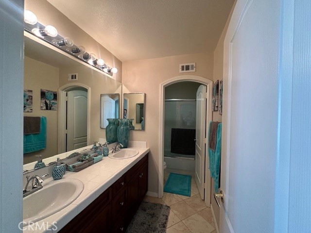 23422 Camino Terraza Road Corona, CA 92883 - Photo 37 of 47 a bathroom with a double vanity sink and a mirror