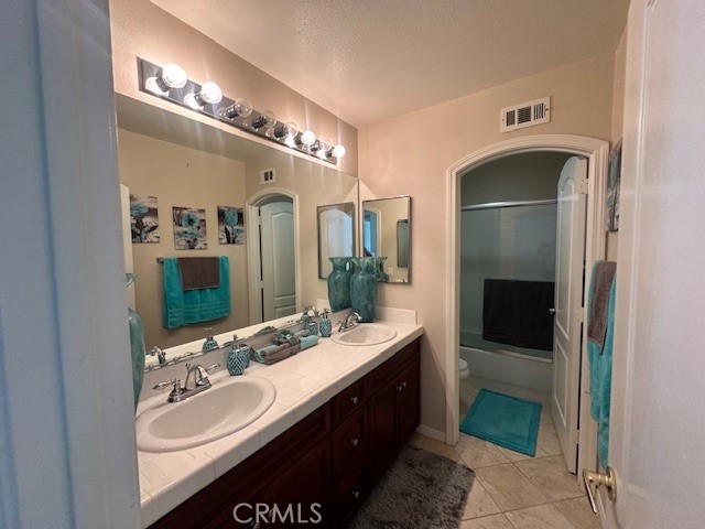 23422 Camino Terraza Road Corona, CA 92883 - Photo 38 of 47 a spacious bathroom with a double vanity sink and a mirror