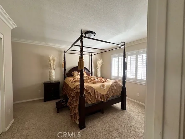 a bedroom with a bed and a mirror
