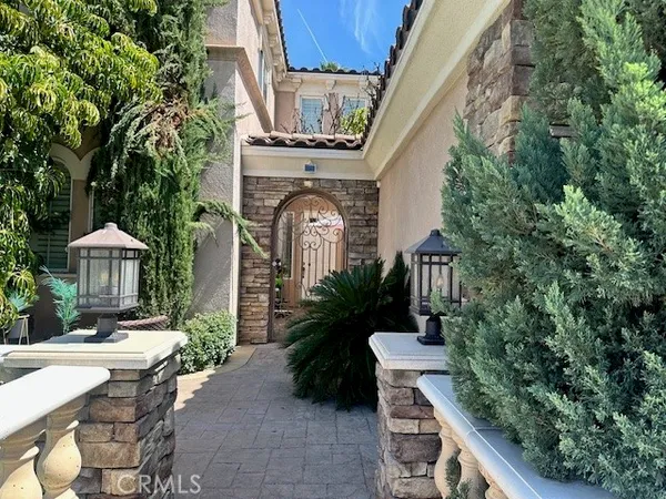 a view of a patio with table and chairs potted plants and large tree