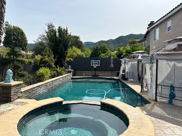23422 Camino Terraza Road Corona, CA 92883 - Photo 46 of 47 a view of a swimming pool with a patio and a lake view