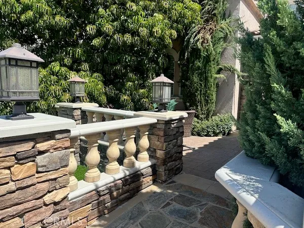 a view of an outdoor sitting area with brick walls
