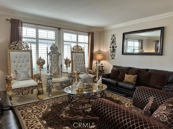 a living room with furniture and a floor to ceiling window