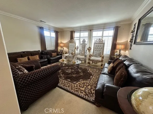 a living room with furniture and a floor to ceiling window