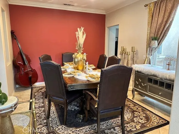 a dining room with furniture and wooden floor