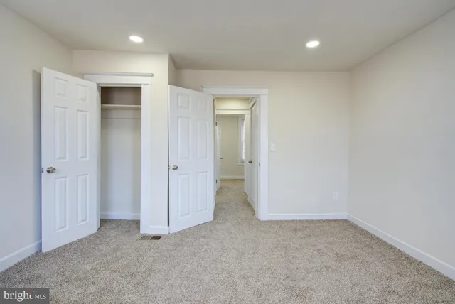 an empty room with closet area