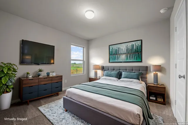 a bedroom with a large bed and a potted plant