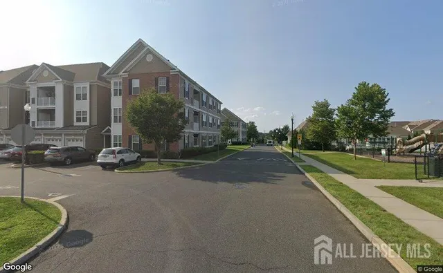 a view of a street with a building in the background