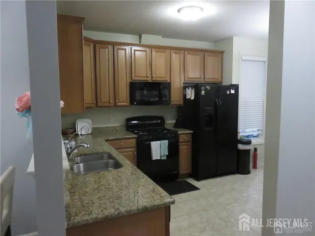 a kitchen with a refrigerator stove and microwave