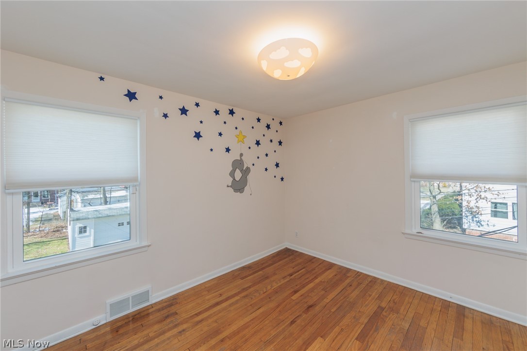 2444 Dysart Road Cleveland, OH 44118 - Photo 27 of 44 Spare room featuring plenty of natural light and hardwood / wood-style flooring